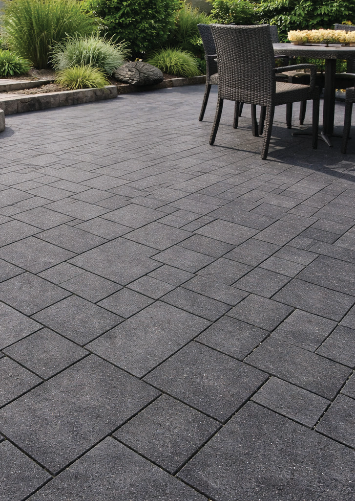 A patio paved in Steel Grey granite with a dining set