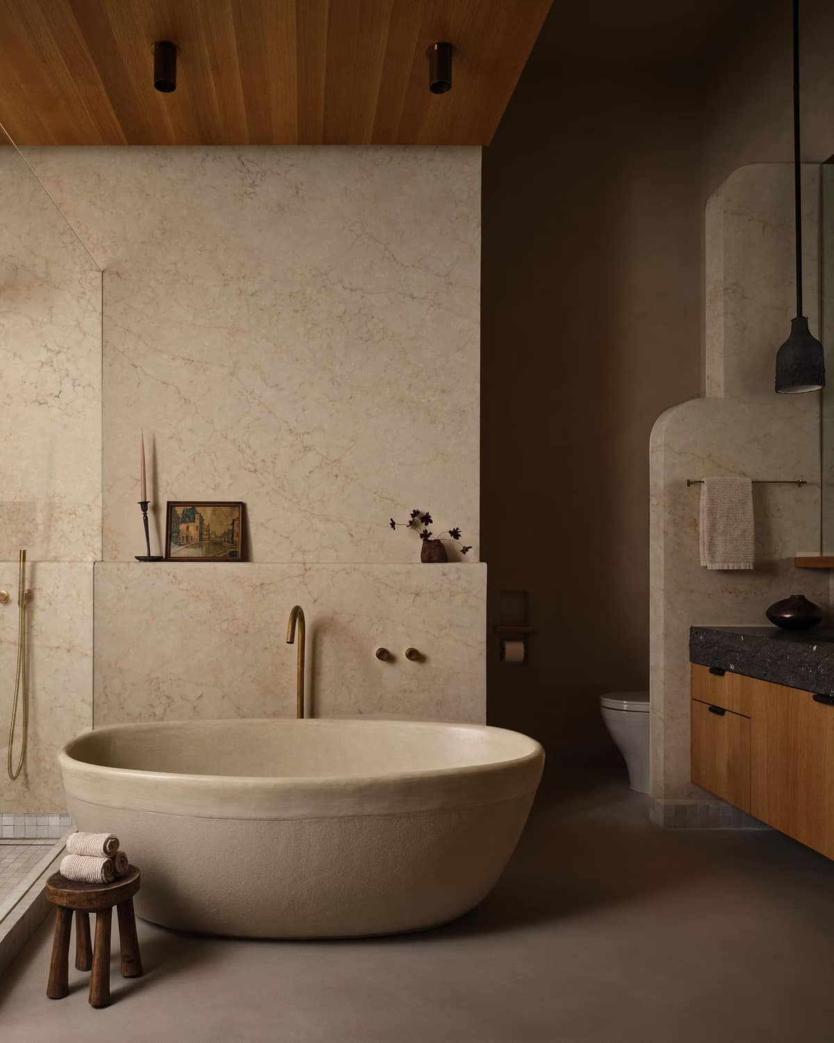 Beige-veined marble bath with a cocoon-shaped tub