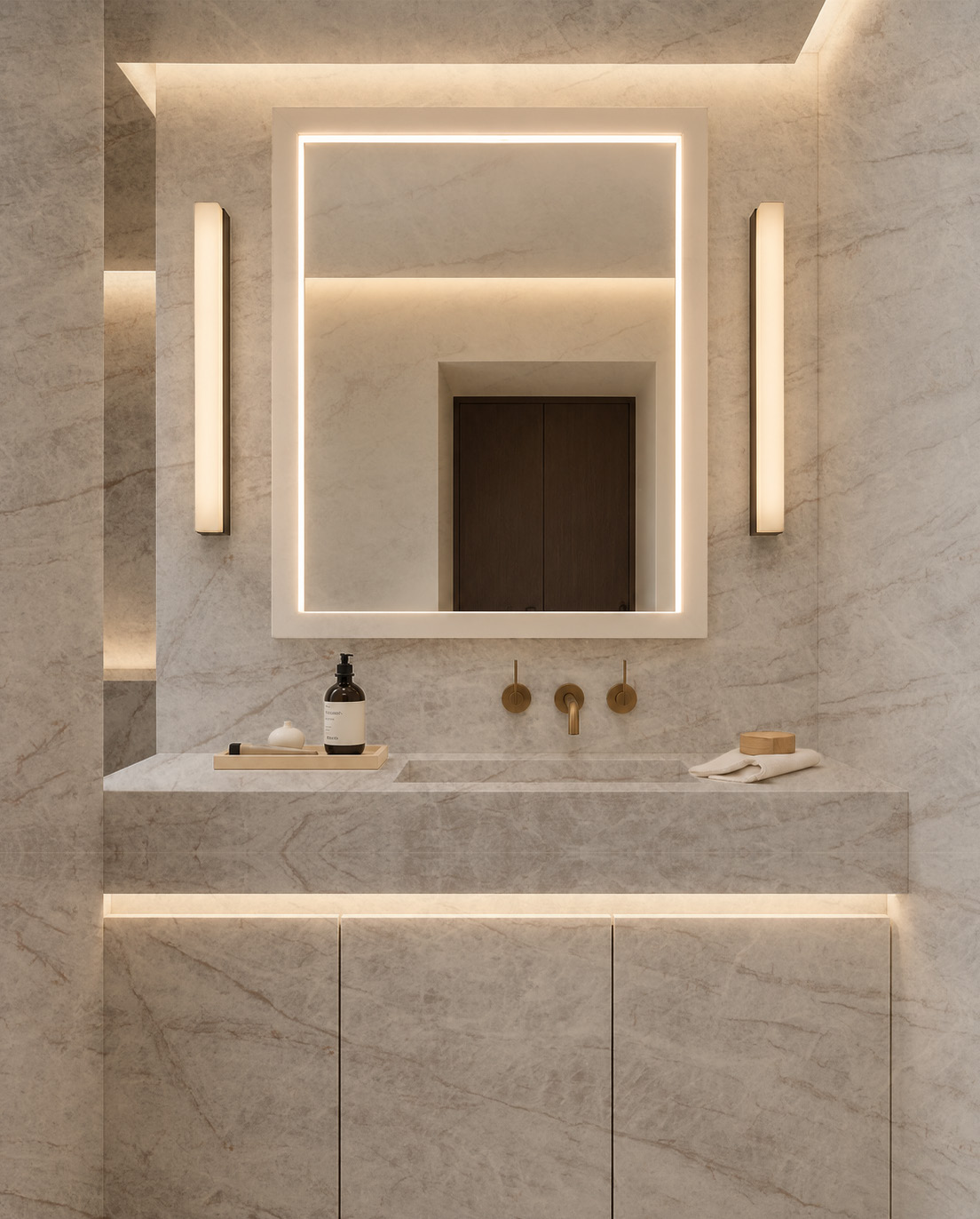 A vanity under a lit mirror