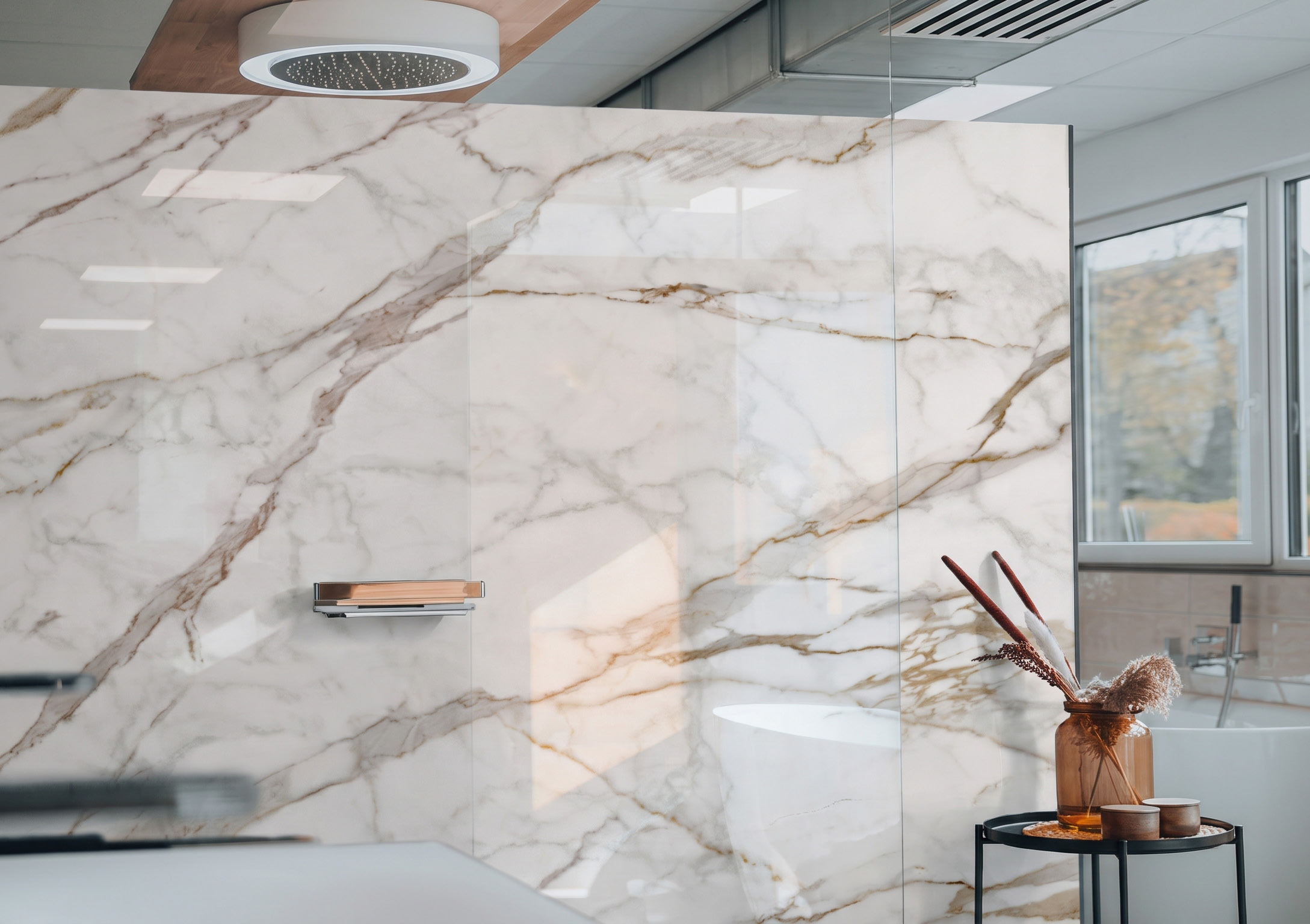 A wall clad in white marble-look slabs