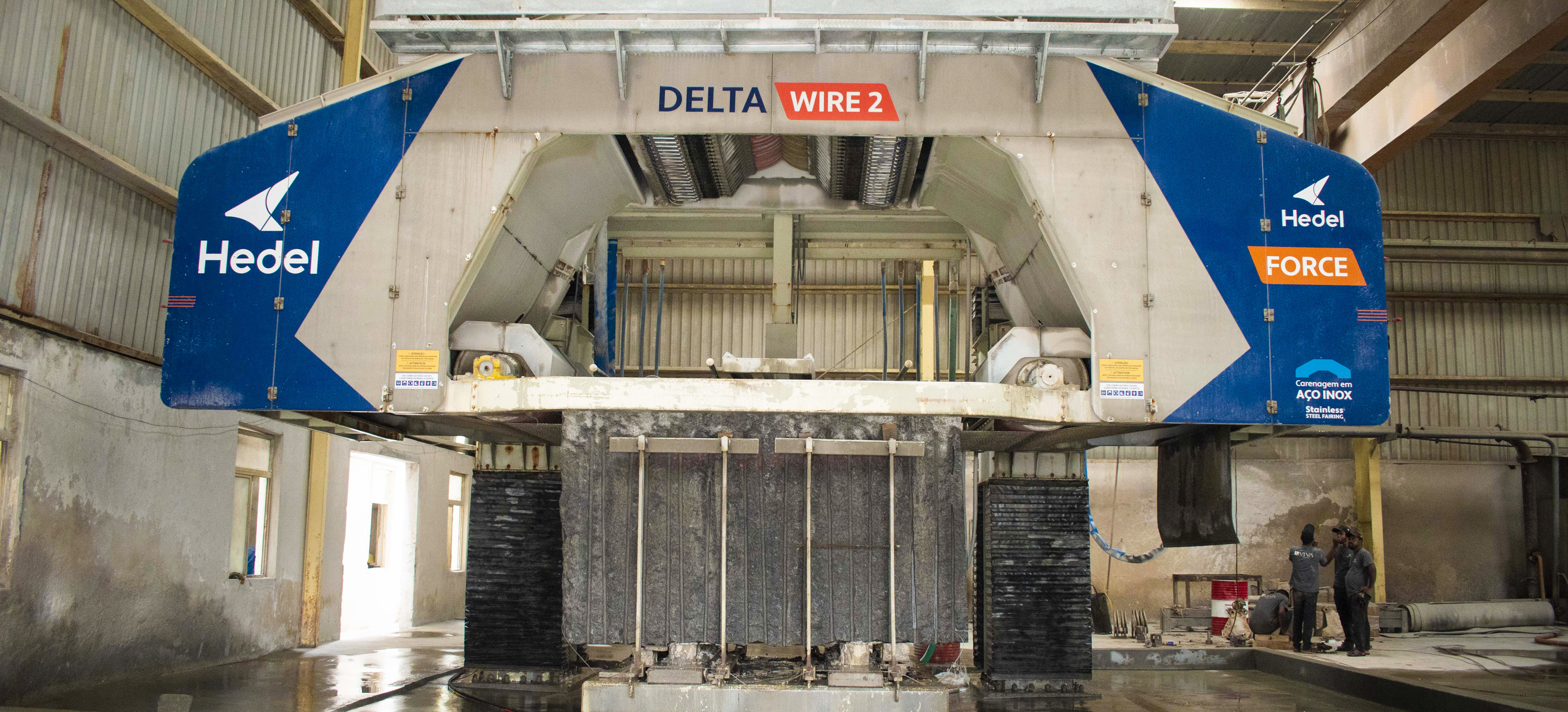 A multi-wire saw slicing a granite block into slabs