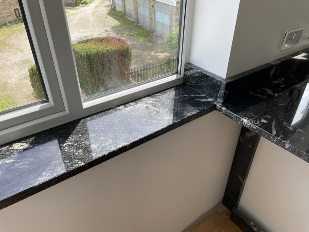 A black and white granite sill turning a corner of the room