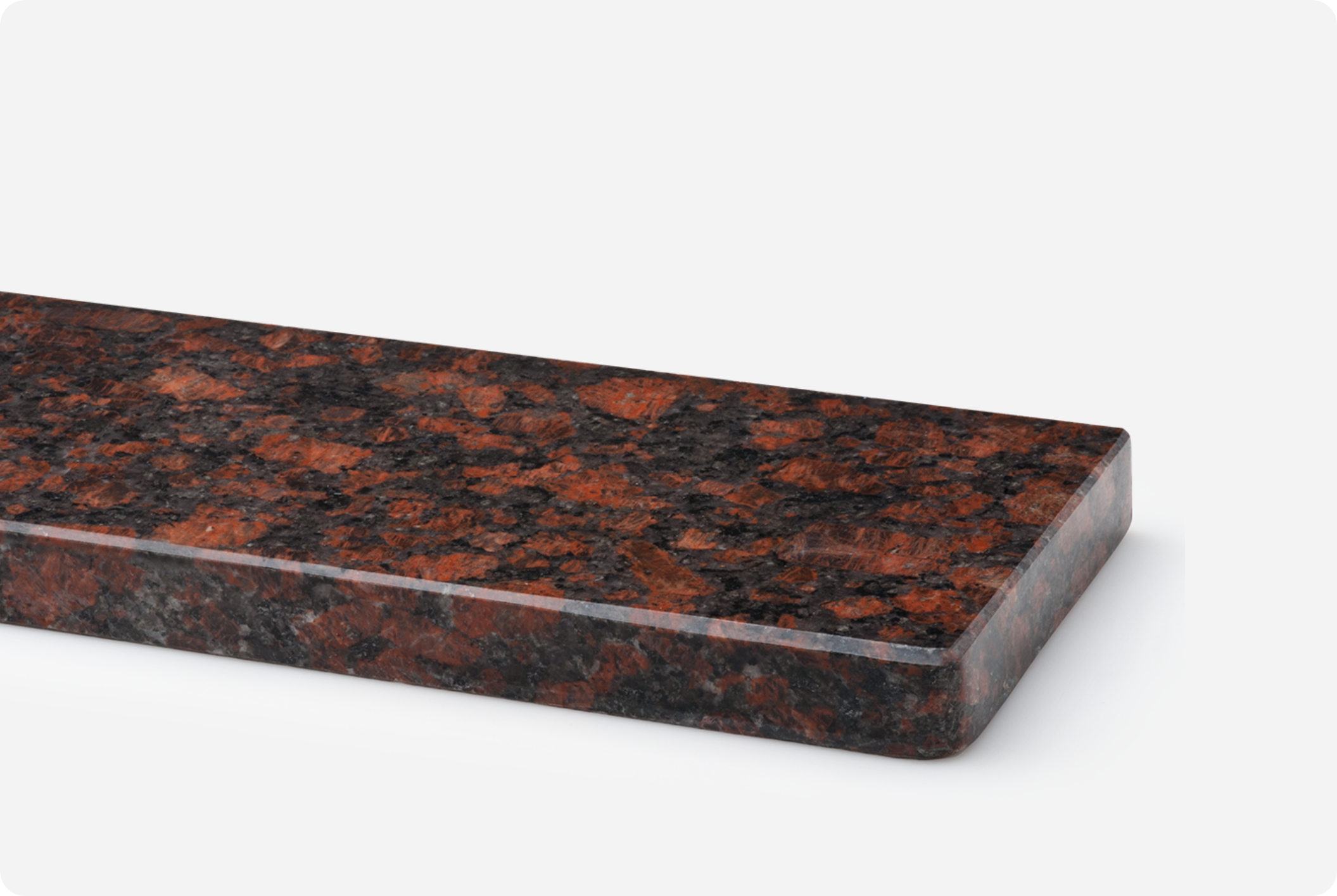 A red granite sill with a rounded front edge